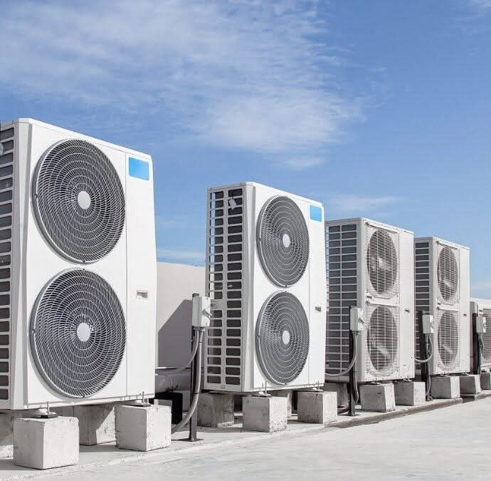 Technician servicing a commercial air conditioning unit